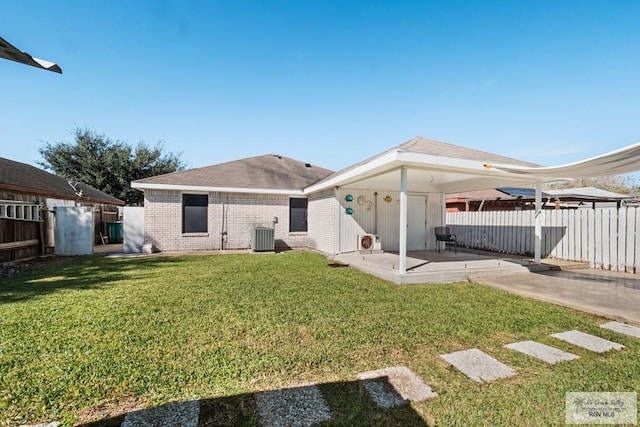 back of property featuring a patio, central AC, and a lawn