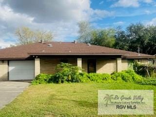 view of front of home featuring a garage and a front lawn