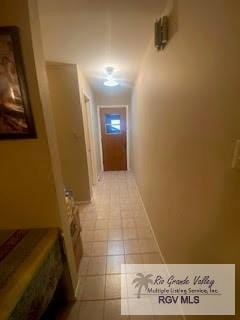 corridor with light tile patterned flooring