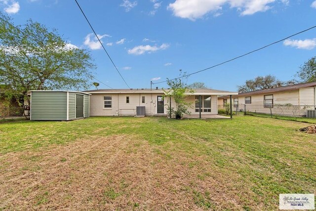1909 E Madison Ave, Harlingen, TX 78550 - back of property with a storage shed, an outbuilding, cooling unit, and a patio