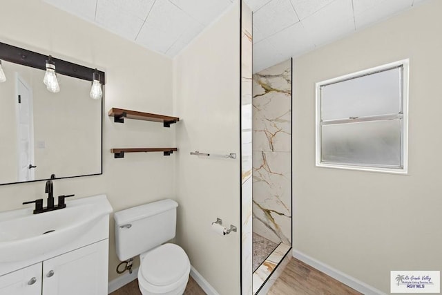 1909 E Madison Ave, Harlingen, TX 78550 - bathroom with toilet, a marble finish shower, vanity, and baseboards
