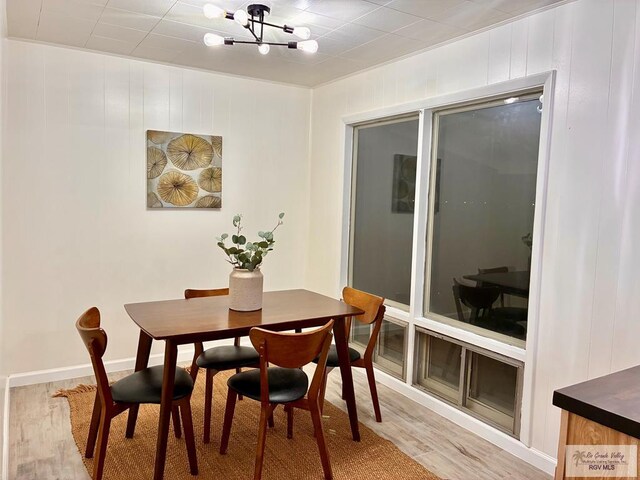 1909 E Madison Ave, Harlingen, TX 78550 - dining area featuring light wood-style flooring and a chandelier