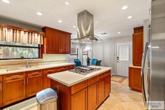 kitchen with a textured ceiling, tasteful backsplash, a kitchen island, island exhaust hood, and stainless steel appliances