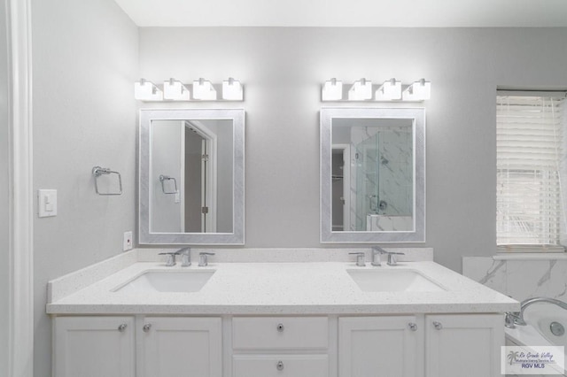 bathroom featuring plenty of natural light, a shower, and vanity