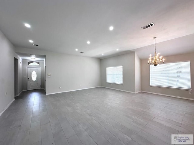 interior space with hardwood / wood-style flooring and an inviting chandelier