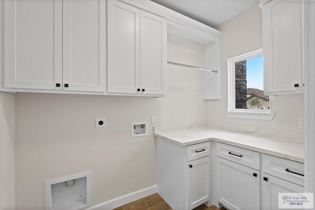 washroom with washer hookup, electric dryer hookup, and cabinets