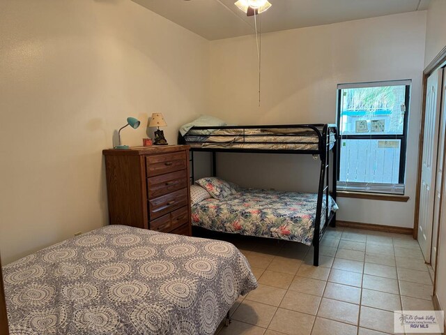 bedroom featuring ceiling fan and light tile patterned floors