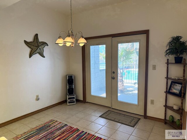 tiled living room featuring ceiling fan and french doors