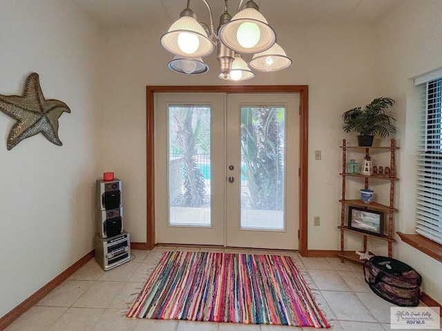 doorway featuring a chandelier and french doors