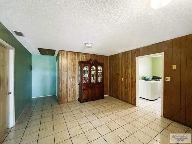 420 4th St, Elsa, TX 78543 - entrance foyer with washer / dryer, wood walls, light tile patterned floors, and a textured ceiling
