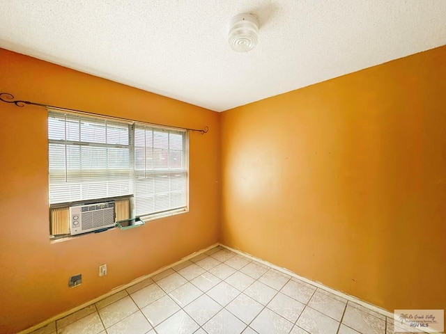 420 4th St, Elsa, TX 78543 - spare room featuring a textured ceiling, light tile patterned floors, a smoke detector, and cooling unit