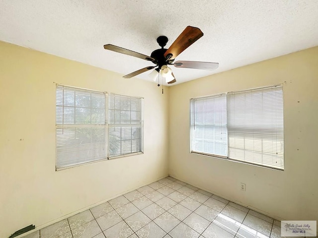 420 4th St, Elsa, TX 78543 - spare room with a ceiling fan, light tile patterned flooring, and a textured ceiling