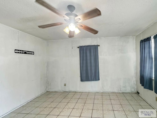 420 4th St, Elsa, TX 78543 - empty room with a textured ceiling, a ceiling fan, and light tile patterned floors