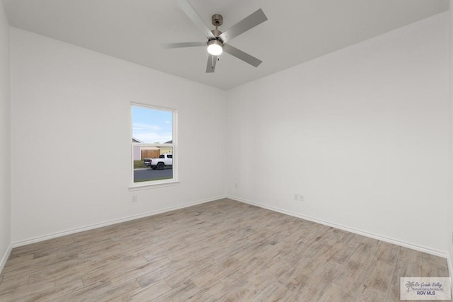 spare room featuring light wood-type flooring and ceiling fan