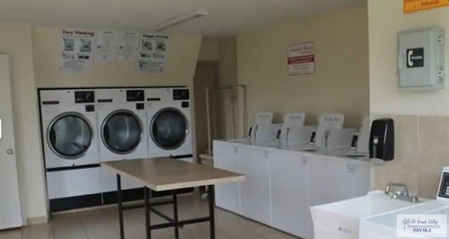 laundry room with electric panel and separate washer and dryer