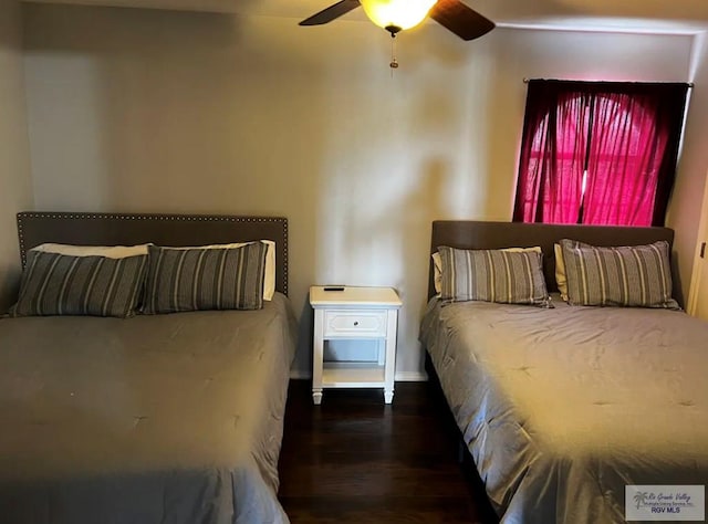 bedroom with ceiling fan and dark wood-type flooring