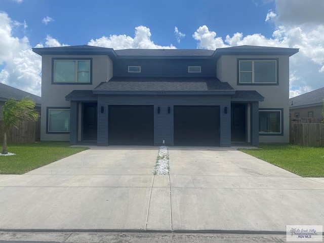 view of front of home featuring a garage and a front lawn