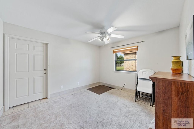 unfurnished office with ceiling fan and light carpet