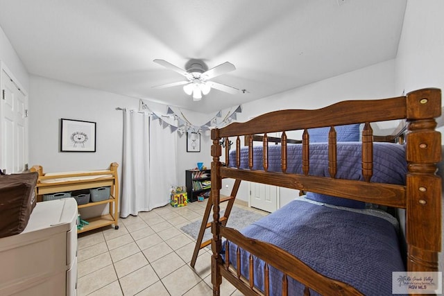 tiled bedroom featuring ceiling fan