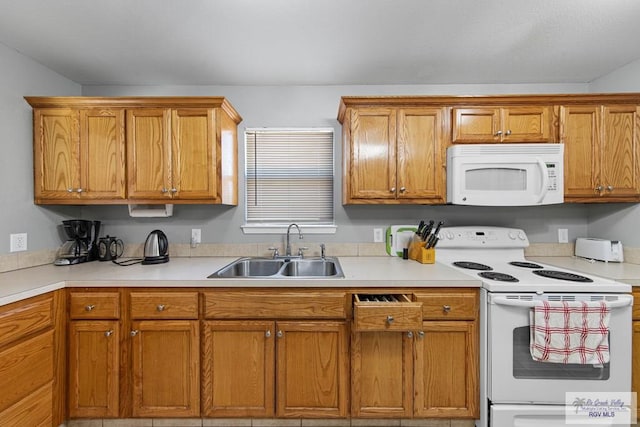 kitchen featuring sink and white appliances