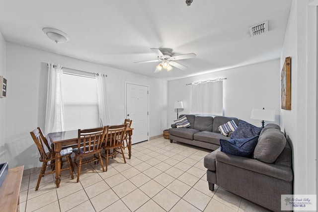 living room with ceiling fan and light tile patterned flooring