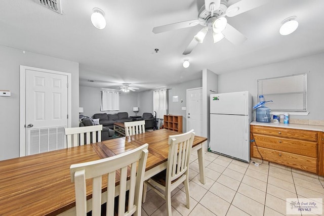 dining area with ceiling fan and light tile patterned floors