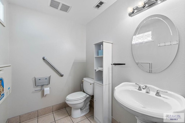 bathroom featuring tile patterned flooring, toilet, and sink