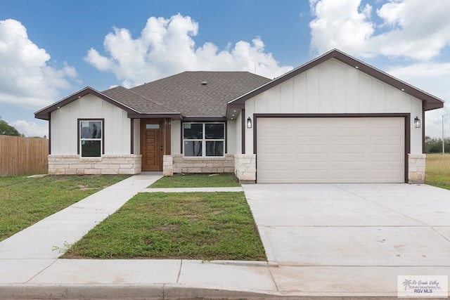 view of front of home with a garage and a front yard