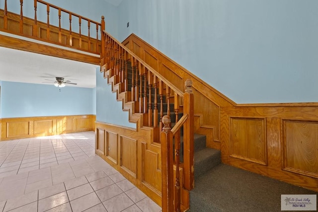 3401 Del Mar Dr, Mission, TX 78574 - stairway featuring ceiling fan, a decorative wall, a wainscoted wall, and tile patterned floors