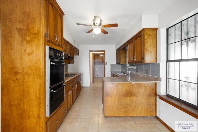 3401 Del Mar Dr, Mission, TX 78574 - kitchen featuring a peninsula, a sink, brown cabinetry, ceiling fan, and black appliances