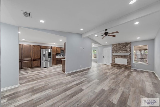 1722 High St, Harlingen, TX 78550 - unfurnished living room featuring light wood-style floors, baseboards, a ceiling fan, and lofted ceiling with beams
