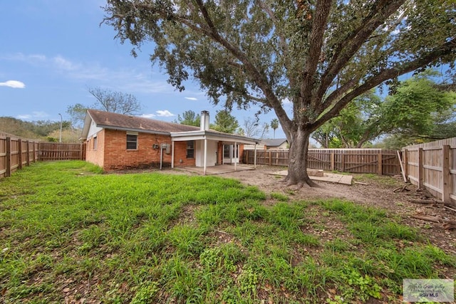 back of property with a yard and a patio