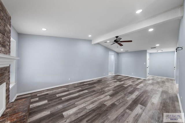1722 High St, Harlingen, TX 78550 - unfurnished living room featuring ceiling fan, lofted ceiling with beams, wood finished floors, a brick fireplace, and baseboards