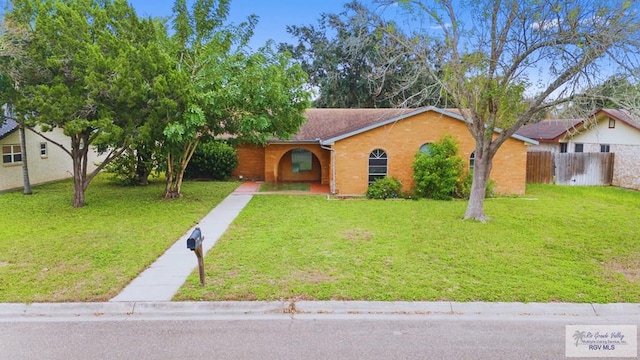1722 High St, Harlingen, TX 78550 - ranch-style house with a front yard, fence, and brick siding