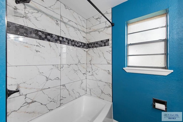 1722 High St, Harlingen, TX 78550 - bathroom with a textured wall and shower / bathtub combination