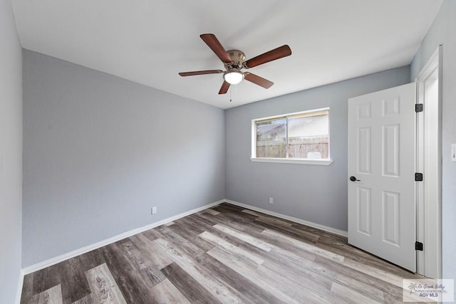 1722 High St, Harlingen, TX 78550 - unfurnished bedroom featuring wood finished floors, baseboards, and a ceiling fan