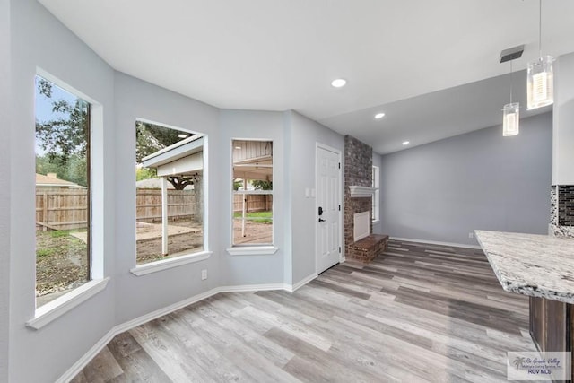 1722 High St, Harlingen, TX 78550 - interior space featuring wood finished floors, a fireplace, and baseboards