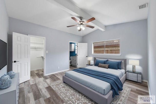 1722 High St, Harlingen, TX 78550 - bedroom with a walk in closet, wood finished floors, lofted ceiling with beams, and visible vents