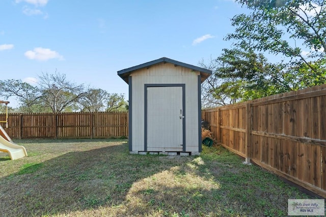 view of outdoor structure featuring a lawn