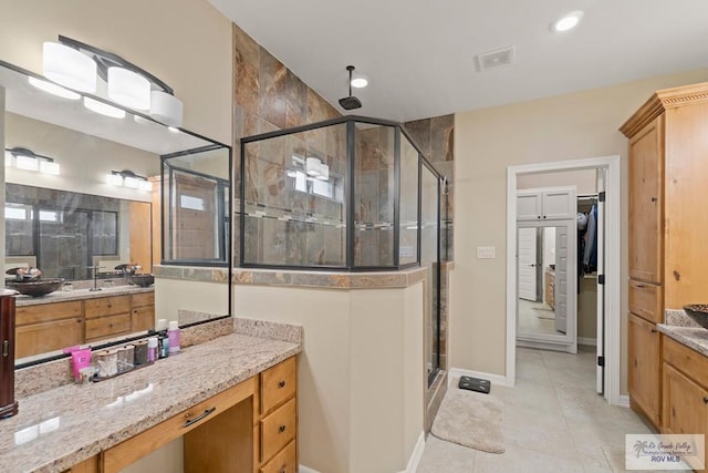 bathroom with tile patterned flooring, vanity, and an enclosed shower