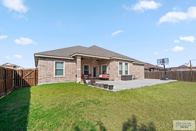 rear view of house with a patio and a lawn