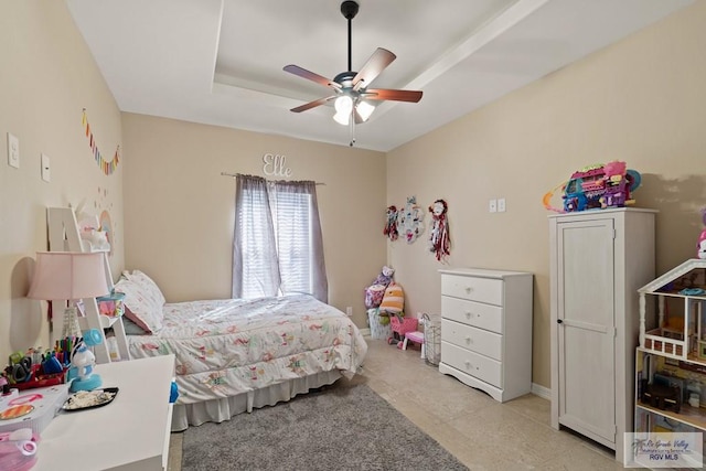 bedroom with ceiling fan and a tray ceiling