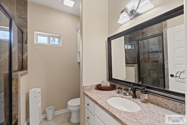 bathroom with an enclosed shower, vanity, and toilet