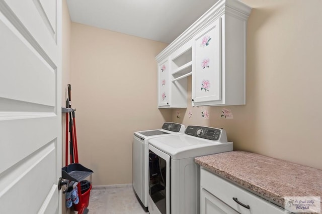 laundry area with cabinets and washing machine and clothes dryer