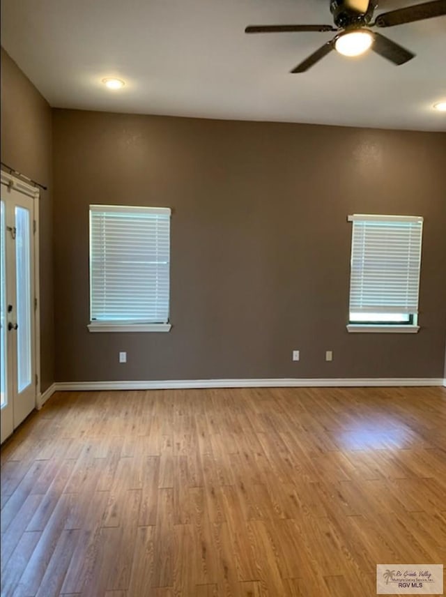 spare room featuring french doors, ceiling fan, and light hardwood / wood-style flooring