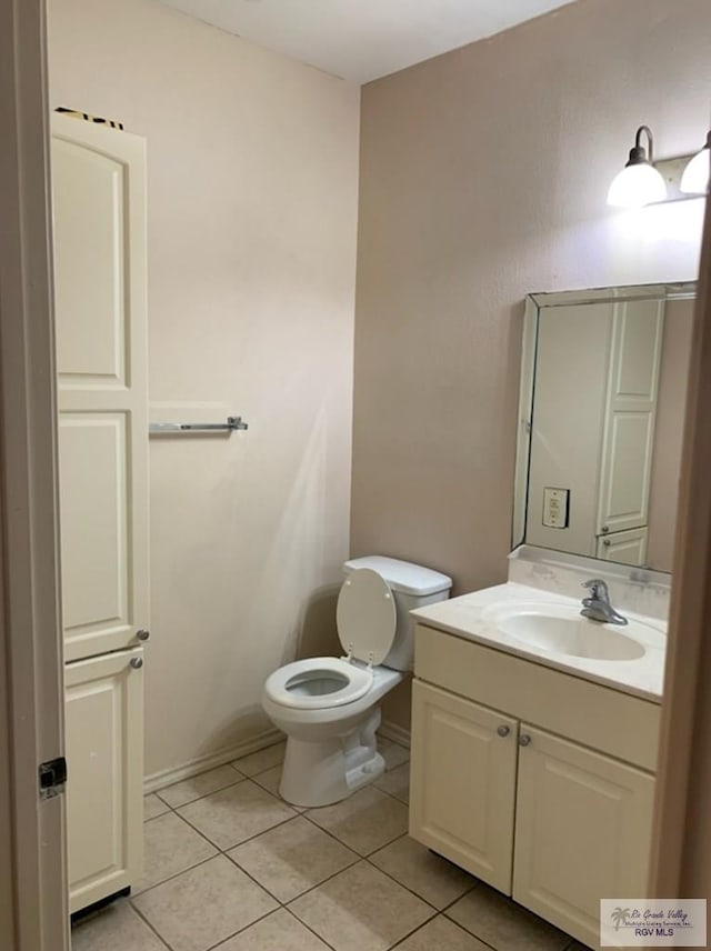 bathroom featuring tile patterned floors, vanity, and toilet