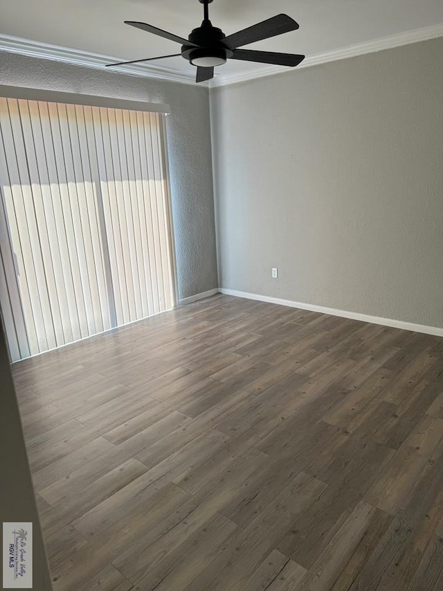 spare room with dark hardwood / wood-style flooring, ceiling fan, and crown molding