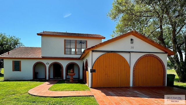 mediterranean / spanish house with a front yard