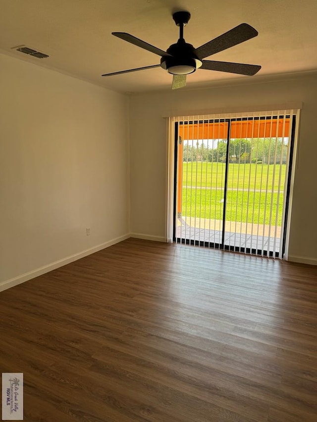 spare room with ceiling fan and dark wood-type flooring