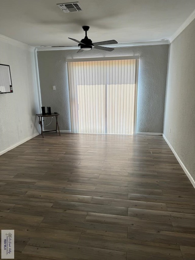 empty room featuring ceiling fan, dark hardwood / wood-style flooring, and ornamental molding